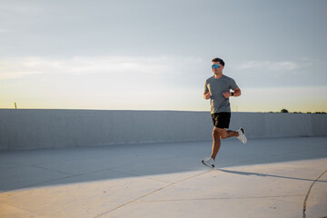 Jogger enjoying an evening run along a sun-kissed pathway at sunset