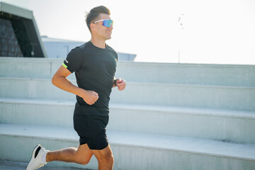 Morning fitness journey unfolds as runner paces through modern outdoor steps