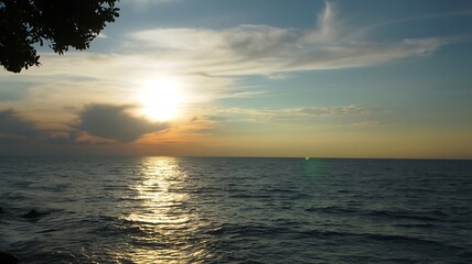 Fototapeta premium Golden sunset over calm ocean waters