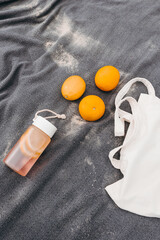 Beach picnic setup with oranges, lemonade in glass jars, and a cozy blanket on the sand. Natural light, summer relaxation, citrus freshness.