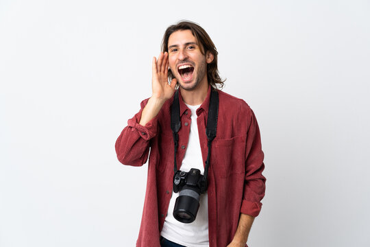 Young photographer man isolated on white background shouting with mouth wide open