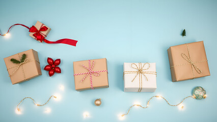 Christmas Shopping with Modern flat lay Christmas gifts in eco wrapping, studio shot, candlelight, soft blue background (relaxed)