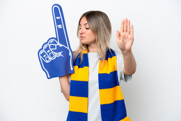 Young Rumanian woman sports fan woman isolated on white background making stop gesture and...