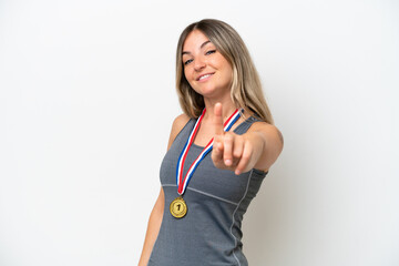 Young Rumanian woman with medals isolated on white background showing and lifting a finger