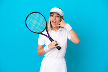 Young tennis player Romanian woman isolated on blue background making phone gesture. Call me back sign