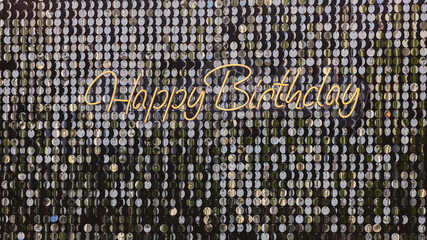 Happy Birthday message written in elegant script, set against a shimmering background