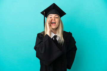 Young university graduate over isolated blue background shouting with mouth wide open