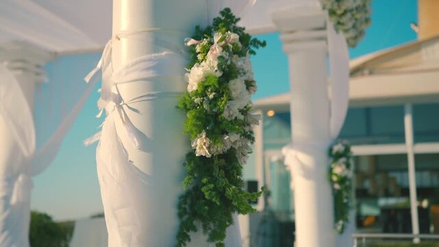 A beautiful white canopy with white flowers on the wedding day. High quality FullHD footage