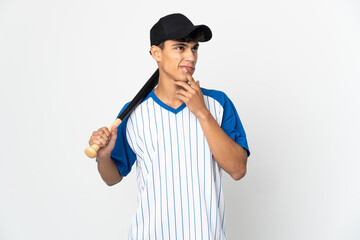 Man playing baseball over isolated white background having doubts while looking up