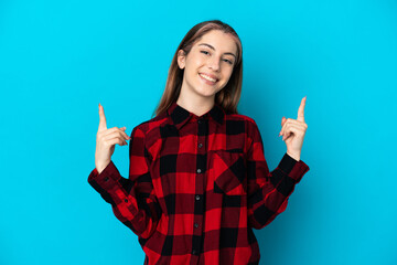 Young caucasian woman isolated on blue background pointing up a great idea