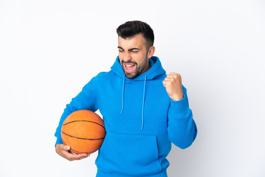 Caucasian man over isolated white background playing basketball