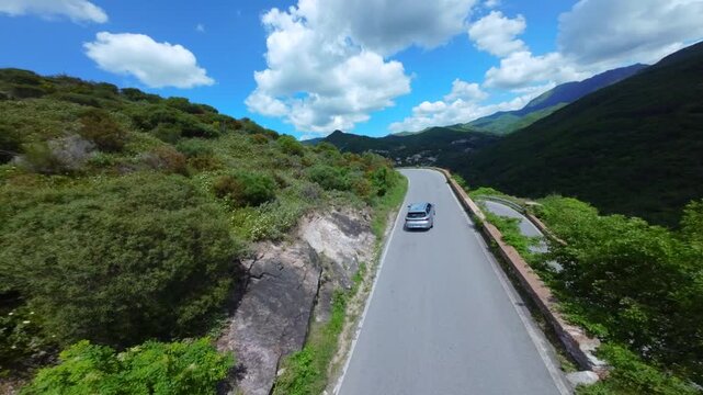 Drone view of serpentine asphalt road in mountainous area in Italian Alps. cars are going on a trip. Green planet. Tourism. Transport. Dangerous road. Italy Bergamo 20.08.2025