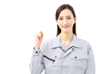 ガッツポーズする作業服の女性 作業員　エンジニア
