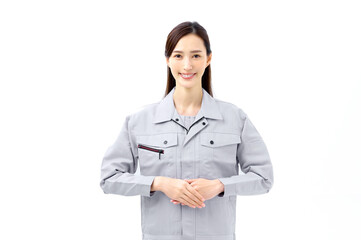 両手を前に置く作業着の女性　あいさつする作業員　エンジニア
