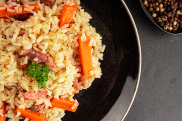 Rice meat and vegetables pilaf fresh delicious gourmet food background on the table rustic food top view copy space