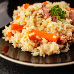 Rice meat and vegetables pilaf fresh delicious gourmet food background on the table rustic food top view copy space