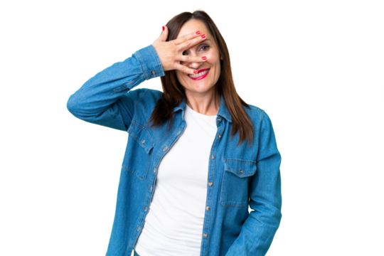 Middle age woman over isolated chroma key background covering eyes by hands and smiling