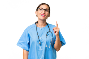 Middle-aged nurse woman over isolated background pointing up and surprised