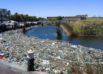 Plastic pollution in canal in Cape Town. Canal filled with plastic waste and debris. South Africa