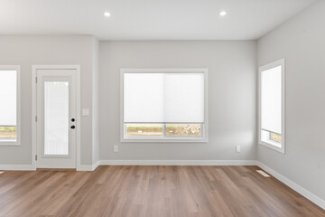 Large room with white walls and wooden floors