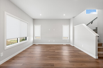 Large, empty room with a staircase in the background