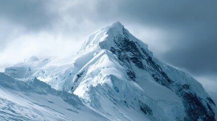 Majestic Snowy Mountain Peak Under Dramatic Clouds