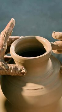 Pottery making with artisan hands on wheel, showing traditional craft and handmade process. 4K, vertical video, social media, 9:16, insta story