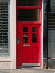 Red door at entrance to tenement flats