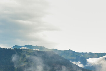 Storm clouds forming over alpine mountain peaks