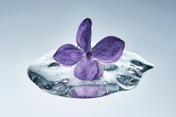 A textured drop of serum with lilac.