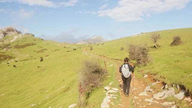 Woman hiking through Gorbea Natural Park's vast landscape