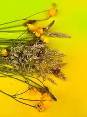 Bouquet with bright yellow flowers in soft natural light.