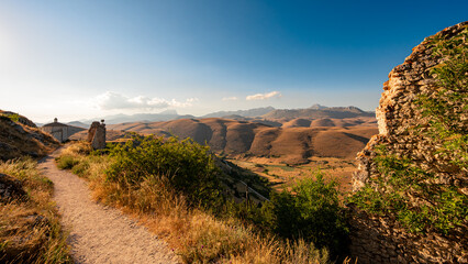 Italy, July 5, 2025: Spectacular view of rolling hills with the mountains of Abruzzo on the horizon at sunset. The clear sky provides the backdrop.