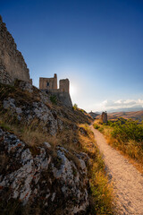 Italy, July 5, 2025: Ruins of Rocca Calascio Castle, an Italian tourist destination and landmark in the Gran Sasso National Park, L'Aquila, Abruzzo. Clear blue skies at sunset.