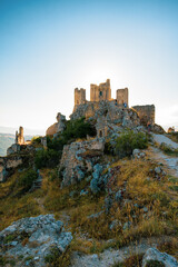 Italy, July 5, 2025: Ruins of Rocca Calascio Castle, an Italian tourist destination and landmark in the Gran Sasso National Park, L'Aquila, Abruzzo. Clear blue skies at sunset.