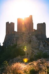 Italy, July 5, 2025: Ruins of Rocca Calascio Castle, an Italian tourist destination and landmark in the Gran Sasso National Park, L'Aquila, Abruzzo. Clear blue skies at sunset.