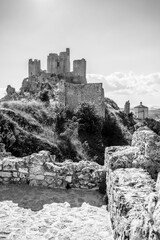Italy, July 5, 2025: Ruins of Rocca Calascio Castle, an Italian tourist destination and landmark in the Gran Sasso National Park, L'Aquila, Abruzzo. Clear blue skies at sunset.