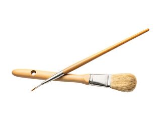 Two paintbrushes are positioned against a solid black background intersecting each other at an angle