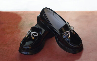 shiny black girls' shoes stand