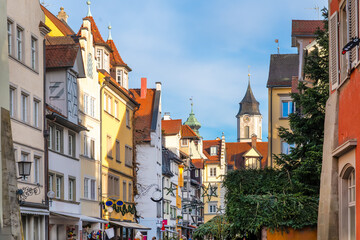 Festively decorated old town alley in Lindau with view of St. Stephan’s Church