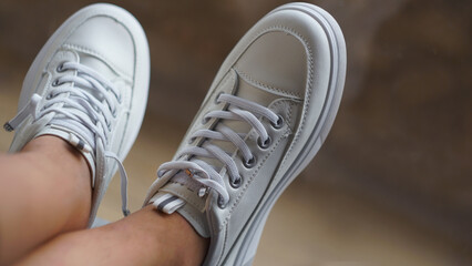 White sneakers on feet