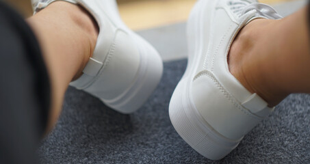 White sneakers on feet