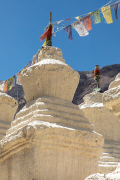 Ancient stupas in Charasa with colorful prayer flags