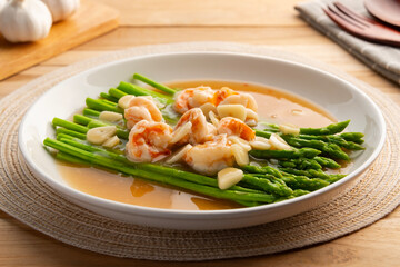 Asparagus with Shrimp and Garlic thick Sauce in white plate.