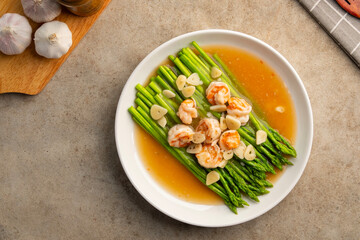 Asparagus with Shrimp and Garlic thick Sauce in white plate.Top view.