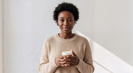 American african Young Woman Holding Coffee in Front of White Wall