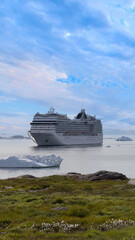 Iceberg seen from cruise ship vacation near Greenland coast in Arctic circle near Ilulissat Disko Bay.
