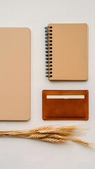 Flat lay of notebooks card holder and wheat stalks for office supplies and stationery