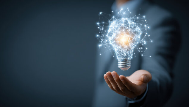 Businessman holding a glowing virtual light bulb with digital network icons