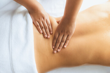 Obraz premium Closeup woman customer enjoying relaxing anti-stress spa massage and pampering with beauty skin recreation leisure in day light ambient salon spa at luxury resort or hotel. Quiescent